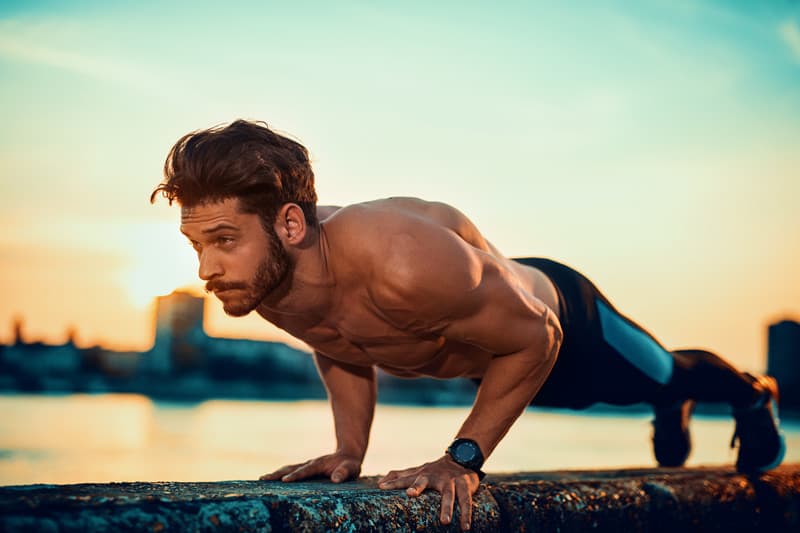 Young man doing push ups outdoors